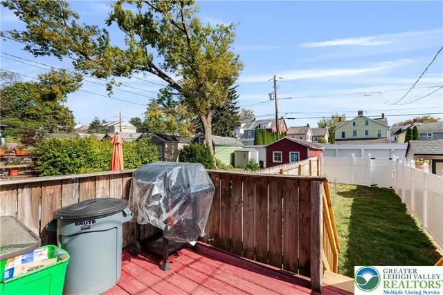 a view of a house with wooden fence