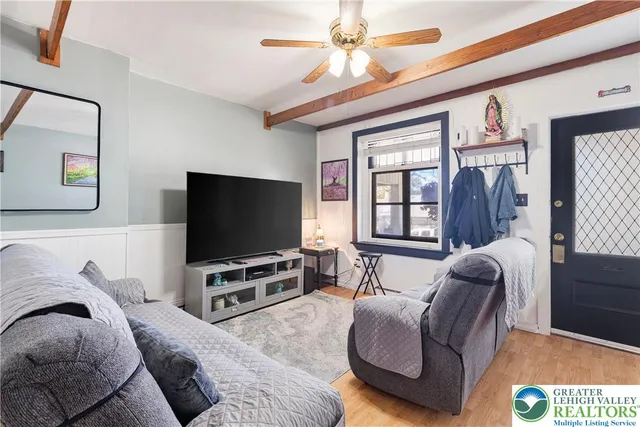 a living room with furniture and wooden floor