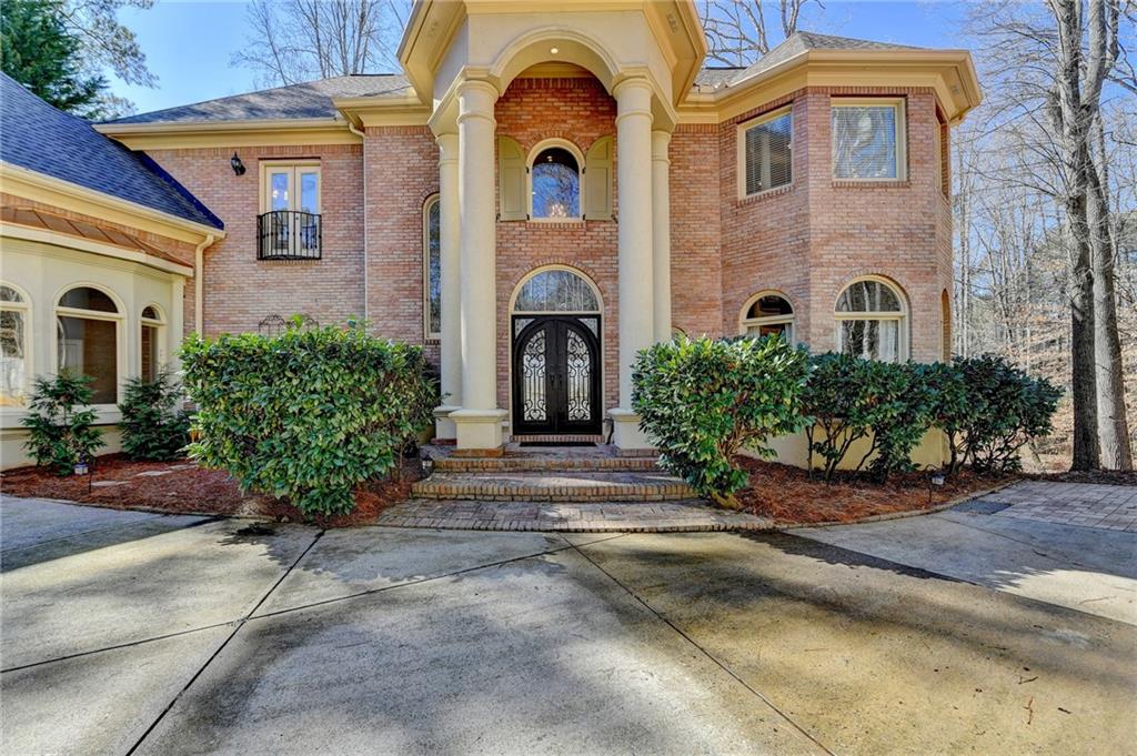 150 Stone Pond Lane Johns Creek, GA 30022 - Photo 1 of 1 a front view of a house with garden