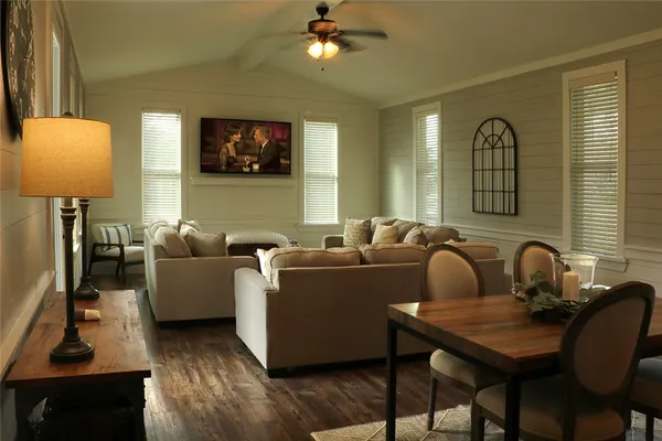 a living room with furniture a lamp and a window