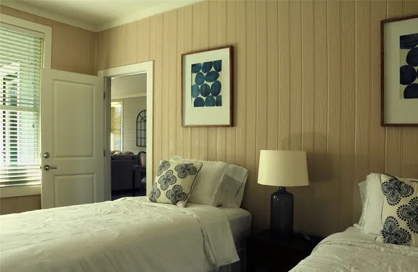 a bedroom with a bed and a painting on the wall