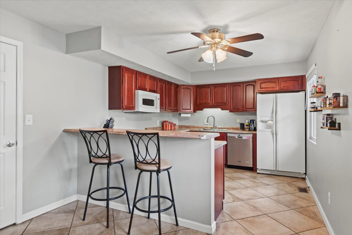 15 Mesa Road Springfield, IL 62702 - Photo 12 of 42 a kitchen with stainless steel appliances kitchen island granite countertop a refrigerator a stove top oven a sink and dishwasher
