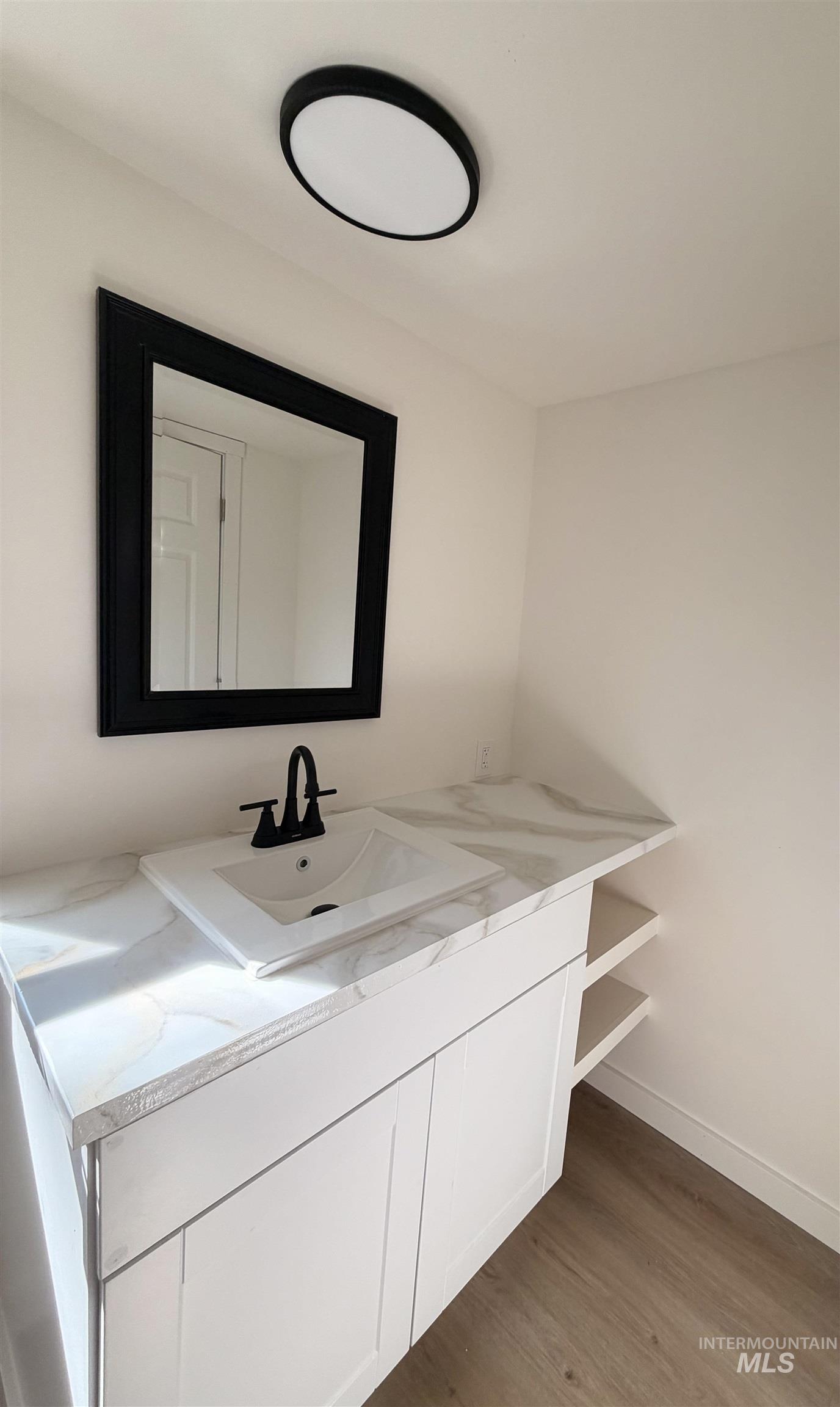 151 View Road Kamiah, ID 83536 - Photo 23 of 49 Modern vanity featuring a white rectangular sink, matte black faucet, and white countertop with veining
