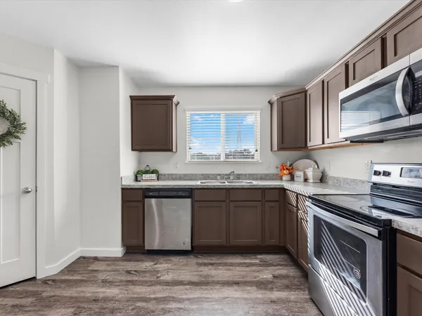 a kitchen with stainless steel appliances granite countertop a sink stove and cabinets