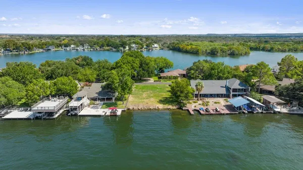 an aerial view of a house with a lake view
