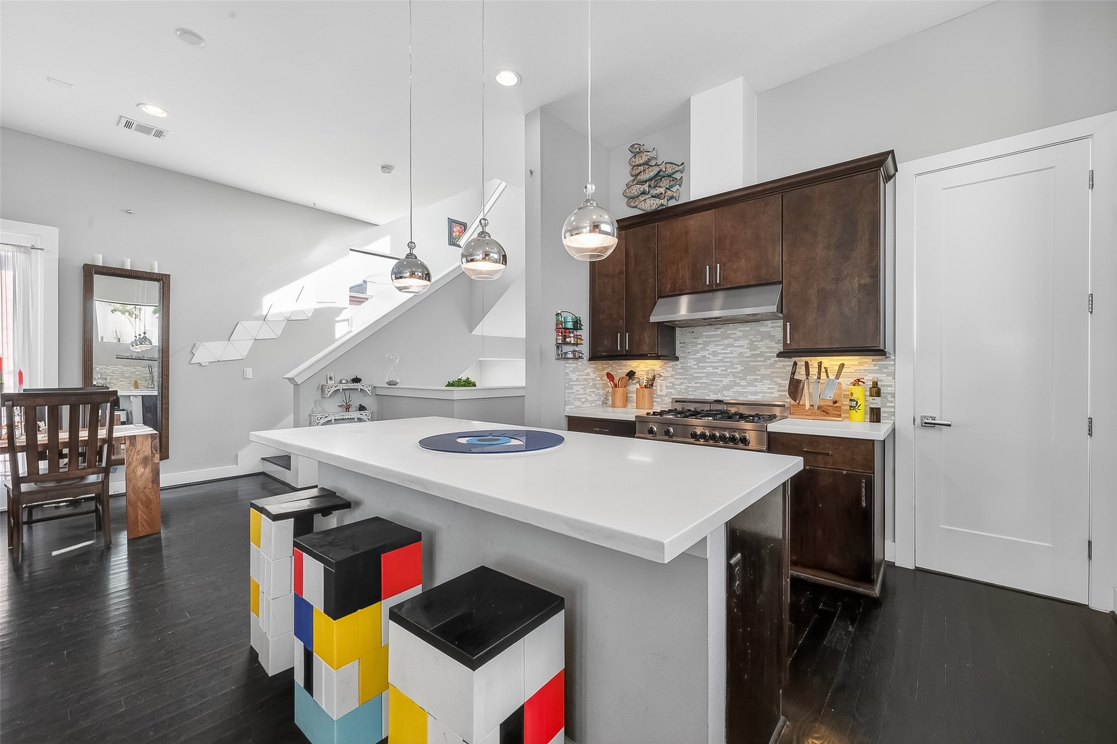 606 Pacific Street Houston, TX 77006 - Photo 19 of 41 a kitchen with a sink a stove and chairs