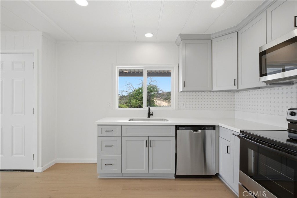 59995 Granite Gulley Road Anza, CA 92539 - Photo 10 of 33 a kitchen with a sink stove and microwave