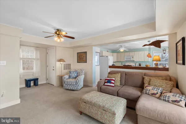a living room with furniture and kitchen view