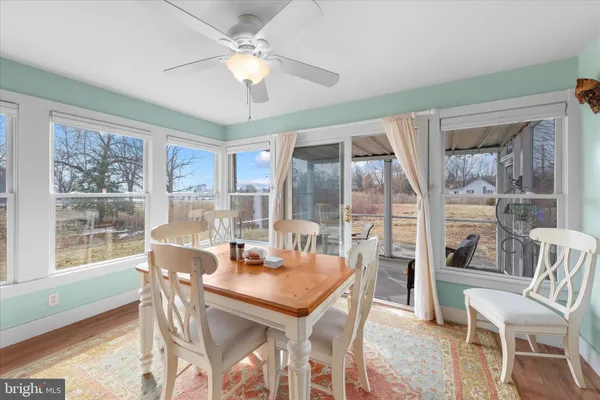 a view of a dining room with furniture large windows and wooden floor