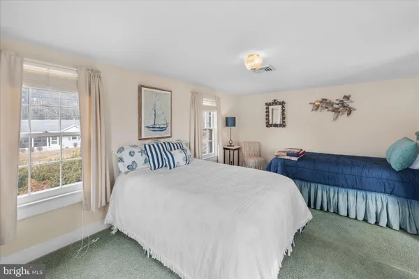 a bedroom with a large bed and a window