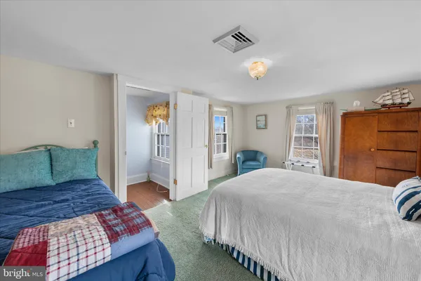 a spacious bedroom with a bed and a couch