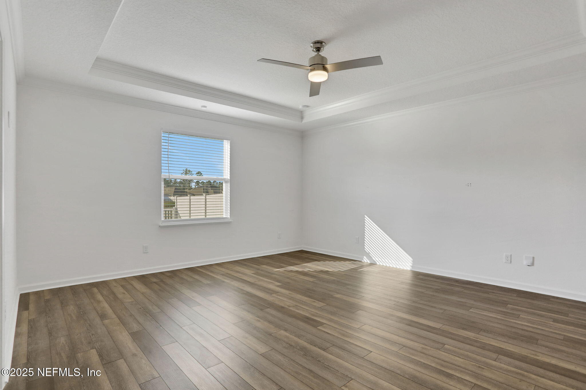 3209 Crocus Ln Green Cove Springs Green Cove Springs, FL 32043 - Photo 13 of 35 an empty room with wooden floor ceiling fan and windows