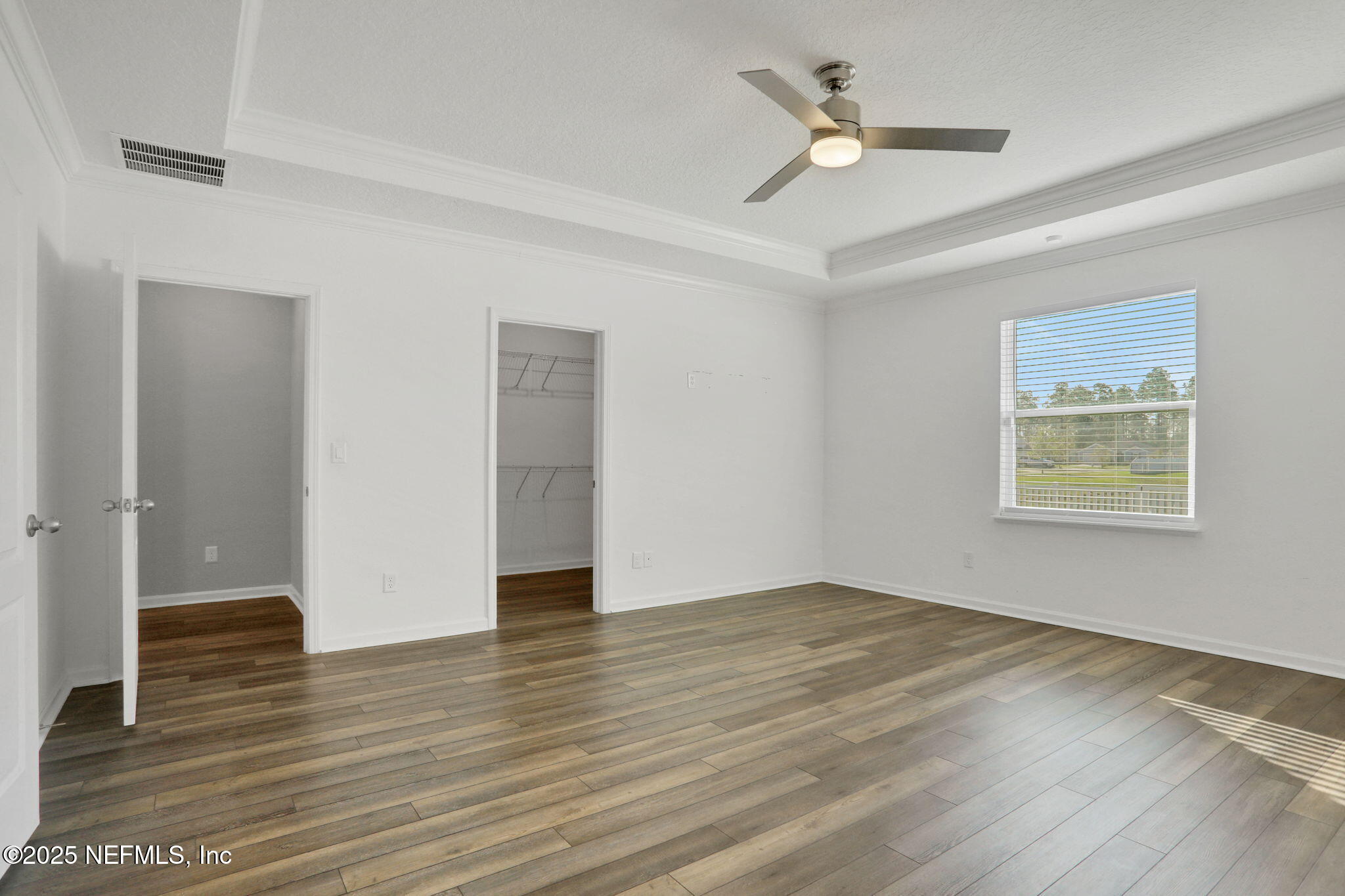 3209 Crocus Ln Green Cove Springs Green Cove Springs, FL 32043 - Photo 14 of 35 an empty room with wooden floor ceiling fan and windows