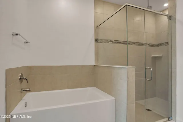 a bathroom with a bathtub and a shower