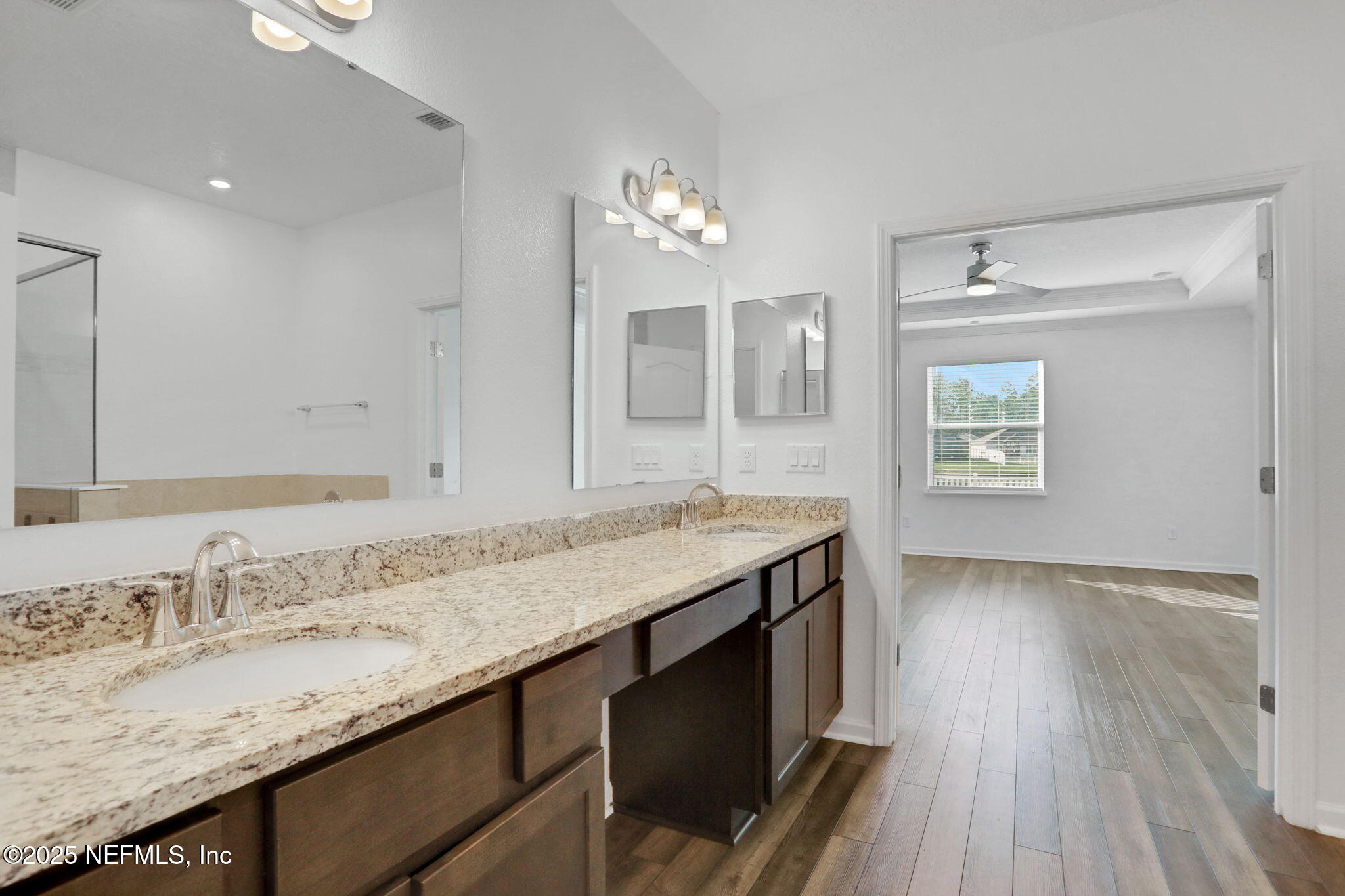 3209 Crocus Ln Green Cove Springs Green Cove Springs, FL 32043 - Photo 20 of 35 a bathroom with a granite countertop sink a light fixture and a mirror
