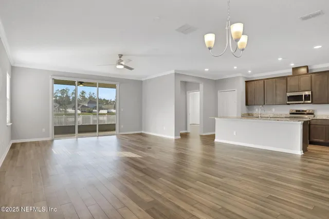 a view of kitchen with sink and wooden floor