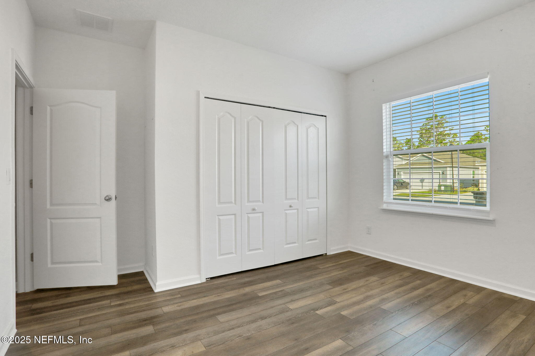 3209 Crocus Ln Green Cove Springs Green Cove Springs, FL 32043 - Photo 23 of 35 a view of an empty room with wooden floor and a window