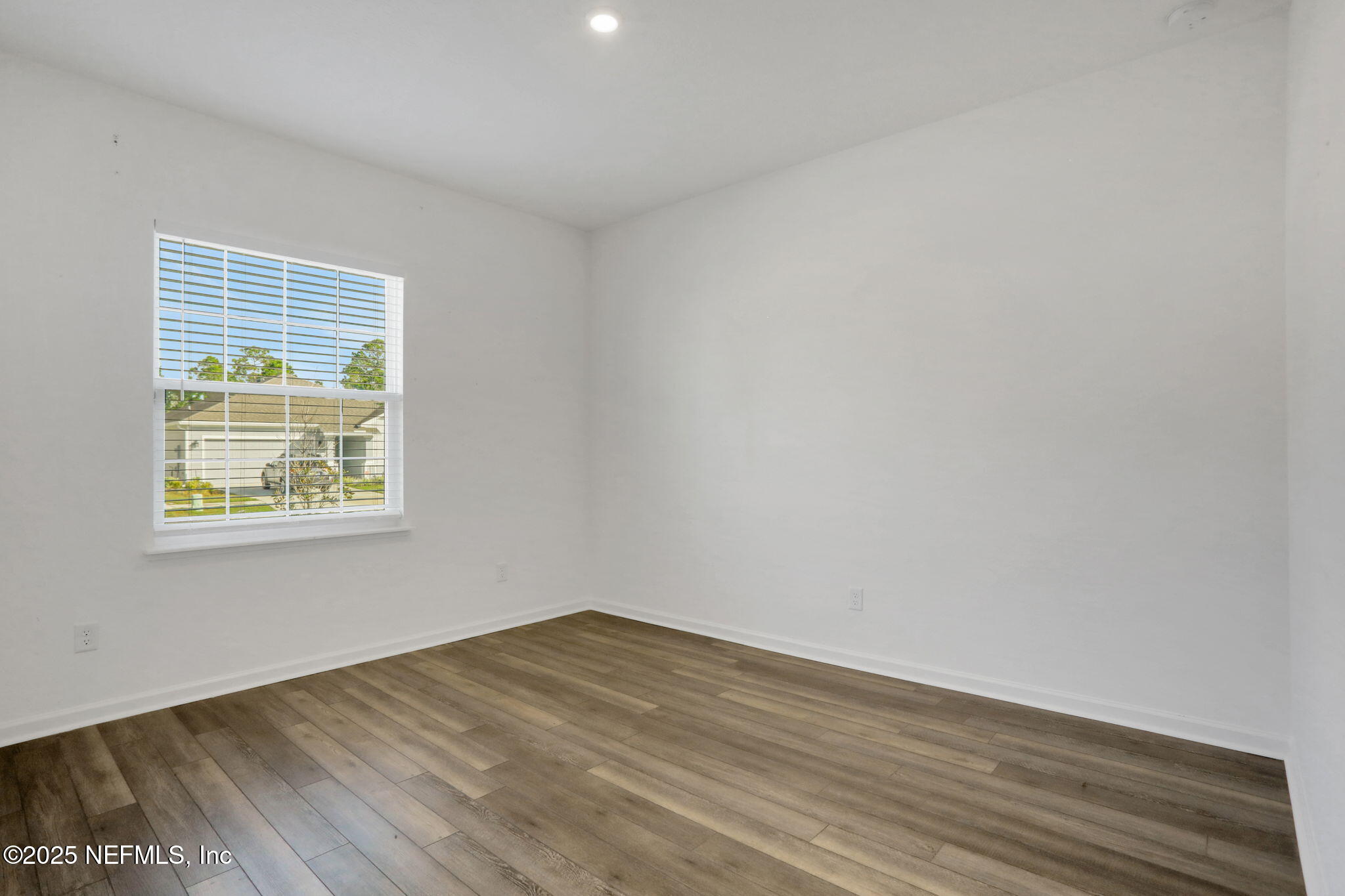 3209 Crocus Ln Green Cove Springs Green Cove Springs, FL 32043 - Photo 24 of 35 a view of an empty room with wooden floor and a window