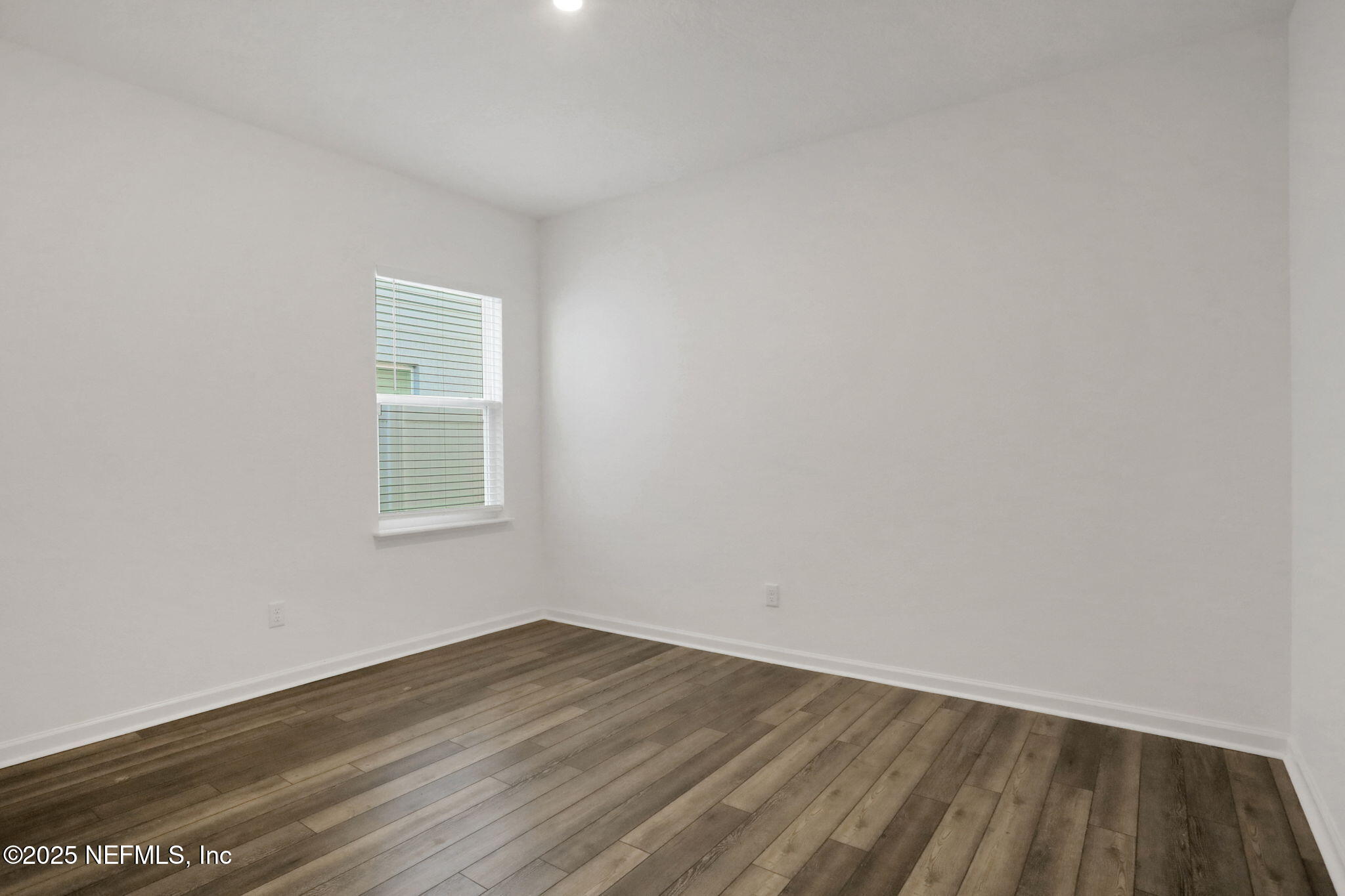 3209 Crocus Ln Green Cove Springs Green Cove Springs, FL 32043 - Photo 27 of 35 a view of an empty room with wooden floor and a window