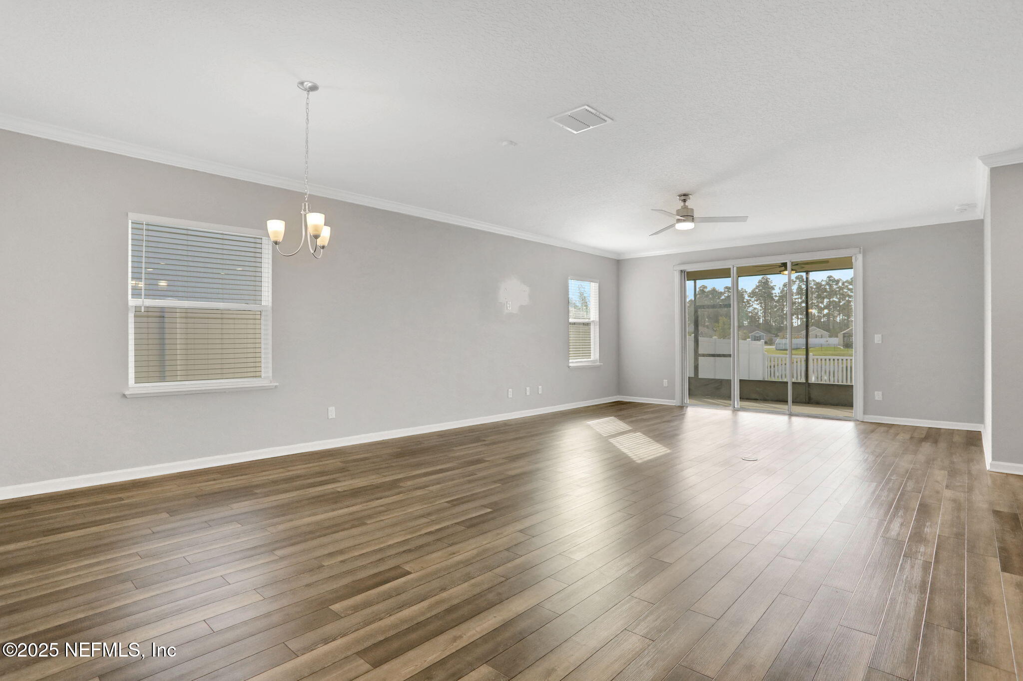 3209 Crocus Ln Green Cove Springs Green Cove Springs, FL 32043 - Photo 3 of 35 a view of an empty room with wooden floor and a window