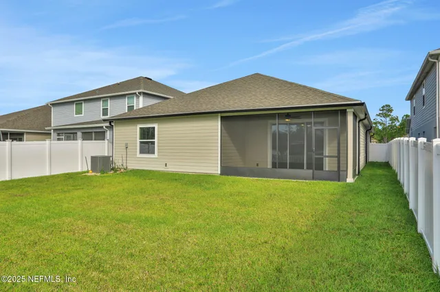 a view of a house with a backyard