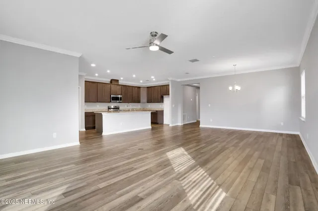 a view of a kitchen with a sink and wooden floor