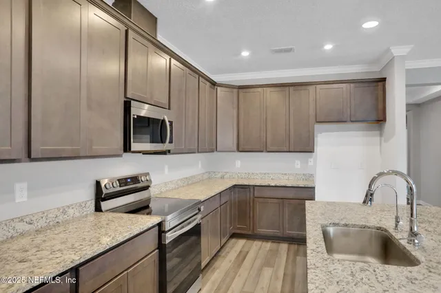 a kitchen with a sink stainless steel appliances and cabinets