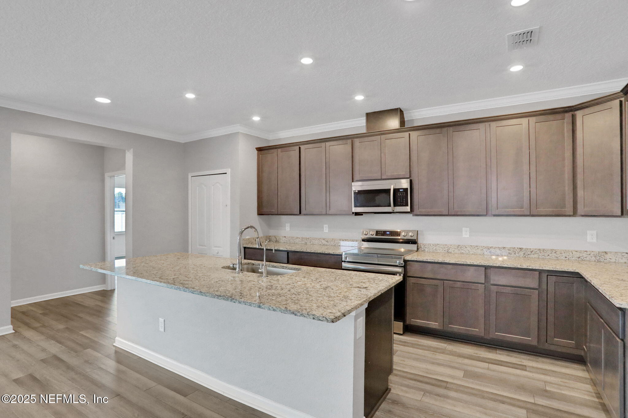 3209 Crocus Ln Green Cove Springs Green Cove Springs, FL 32043 - Photo 8 of 35 a kitchen with kitchen island granite countertop a sink and steel appliances