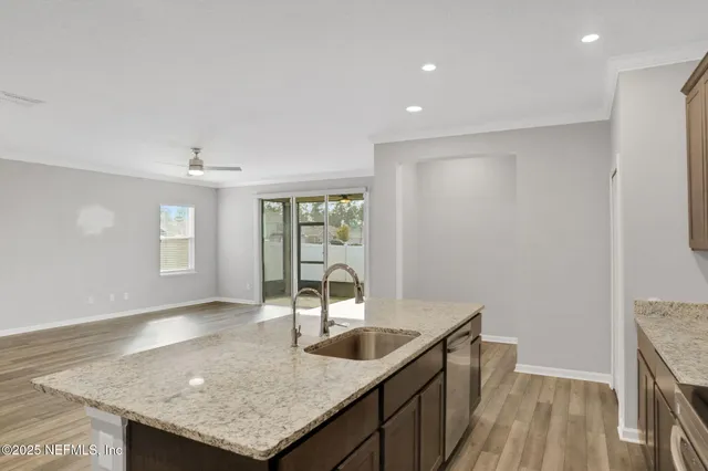 a kitchen with a sink a counter space and a window
