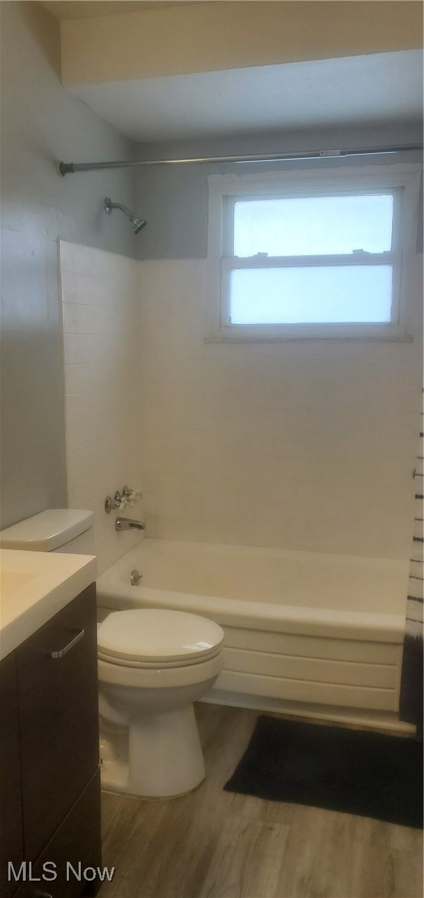30151 Regent Road Wickliffe, OH 44092 - Photo 7 of 17 Full bathroom with vanity, toilet, wood-type flooring, and tub / shower combination