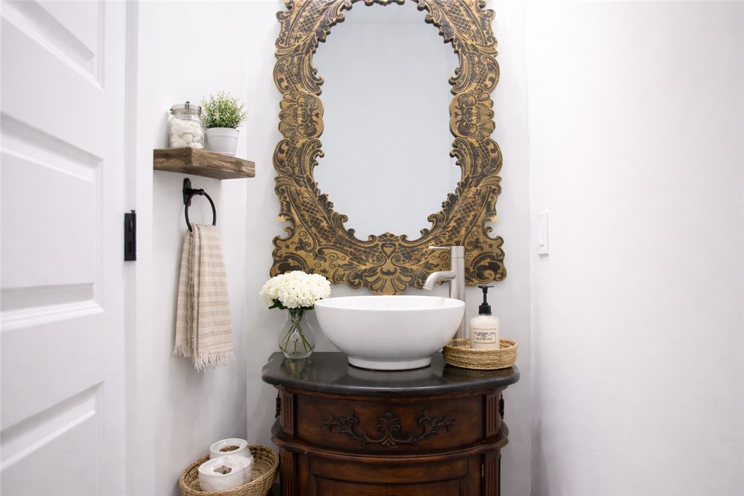 2515 Highway 29 Anderson, SC 29621 - Photo 18 of 38 A vessel sink rests on a dark wood vanity with an ornate, oversized mirror enhancing this powder room's character.