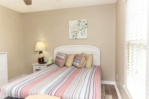 a bedroom with a bed and a window