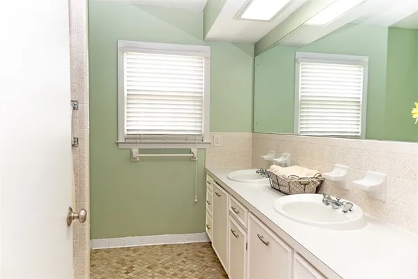 a bathroom with a sink a toilet and a window