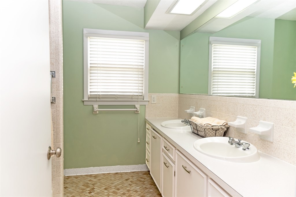 6534 Natha Avenue Columbus, GA 31909 - Photo 12 of 13 a bathroom with a sink a toilet and a window