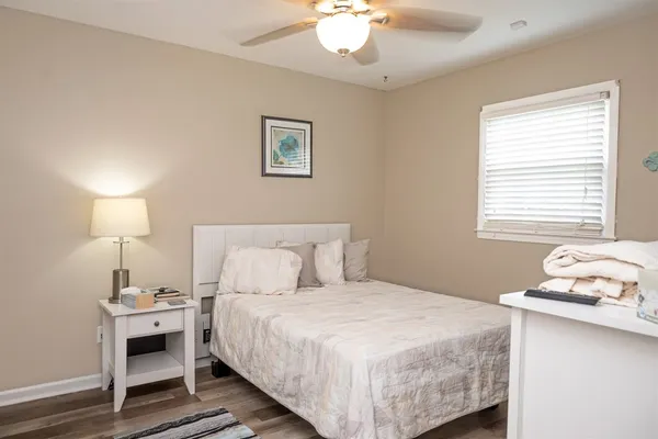 a bedroom with a bed and a lamp