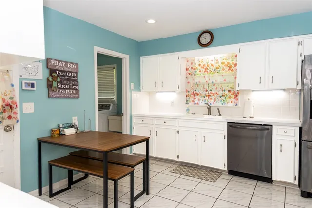 a kitchen with a sink cabinets and wooden floor