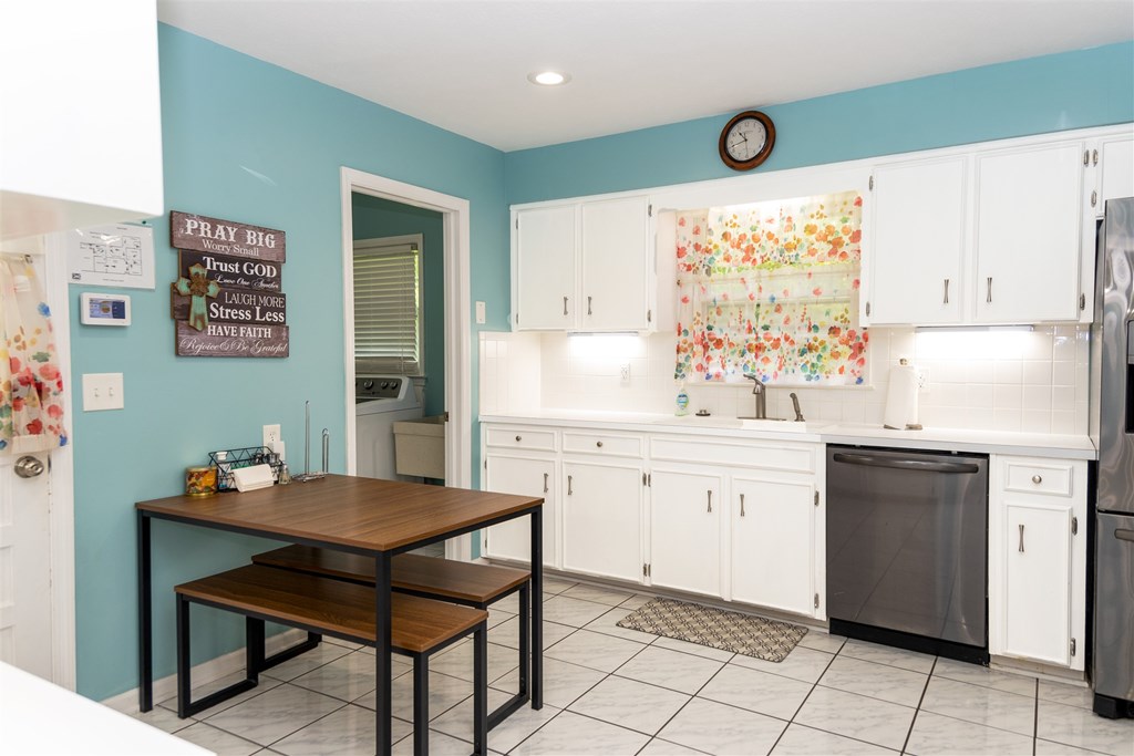 6534 Natha Avenue Columbus, GA 31909 - Photo 2 of 13 a kitchen with a sink cabinets and wooden floor