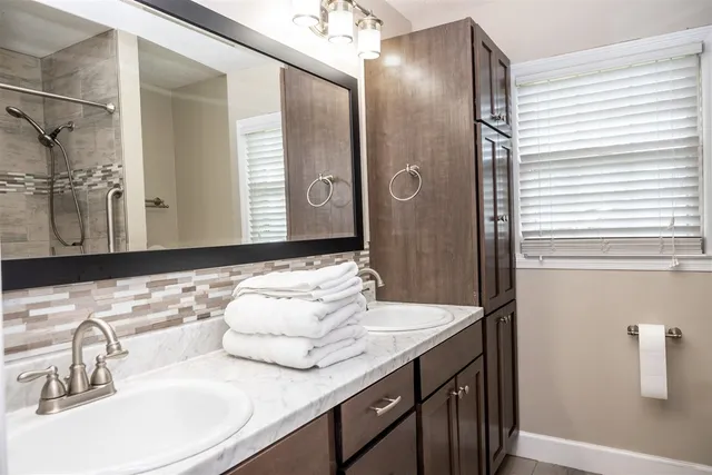 a bathroom with a double vanity sink and a mirror