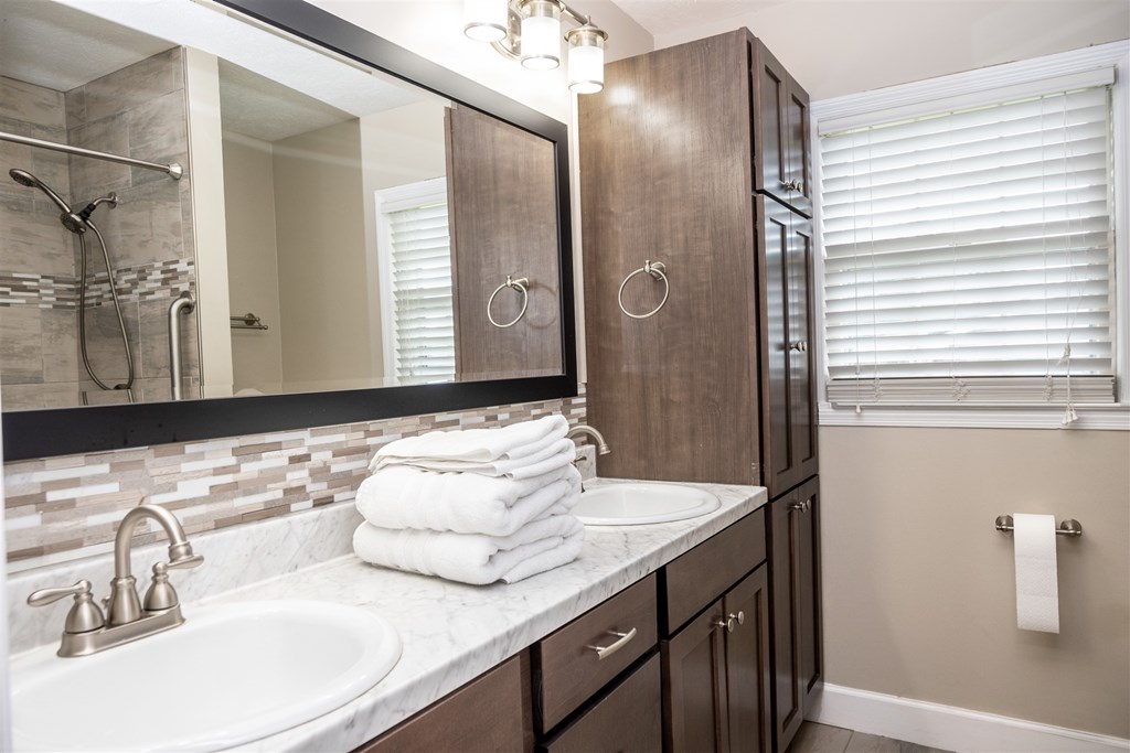 6534 Natha Avenue Columbus, GA 31909 - Photo 7 of 13 a bathroom with a double vanity sink and a mirror