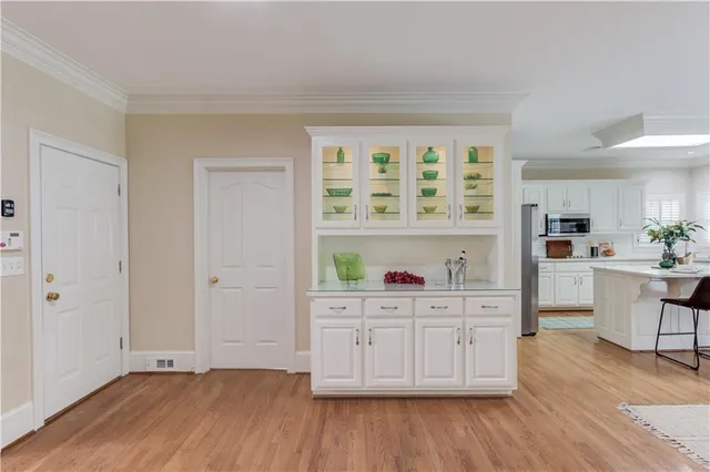 a kitchen with a refrigerator and cabinets