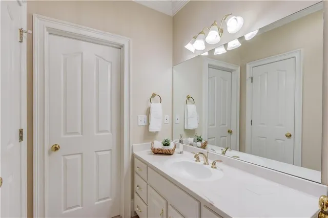 an empty room with chandelier fan and windows