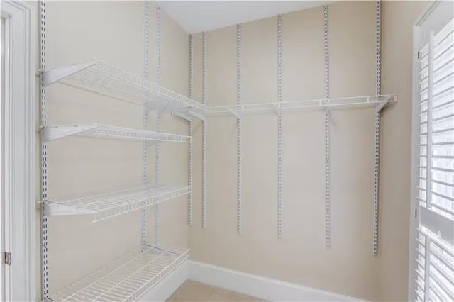 an empty room with a ceiling fan and a window