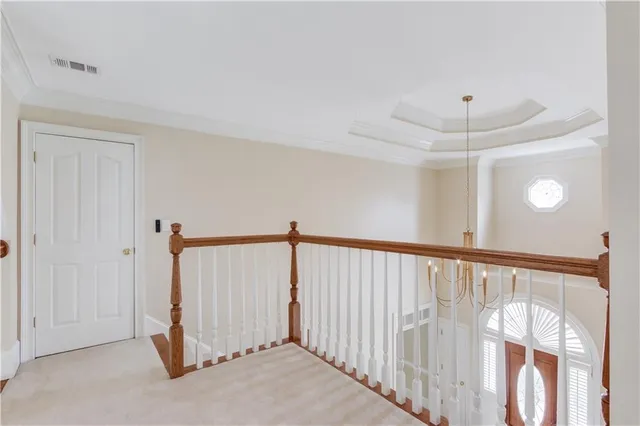a view of staircase with wooden floor and white walls