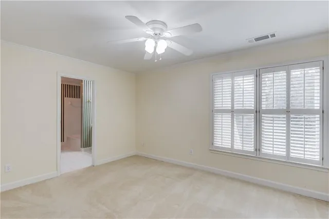 a view of a house with a big yard and large trees