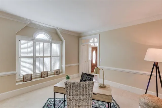 a living room with furniture a fireplace and a large window