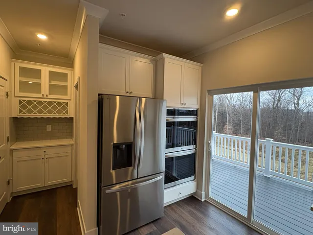a kitchen with stainless steel appliances a refrigerator and a window