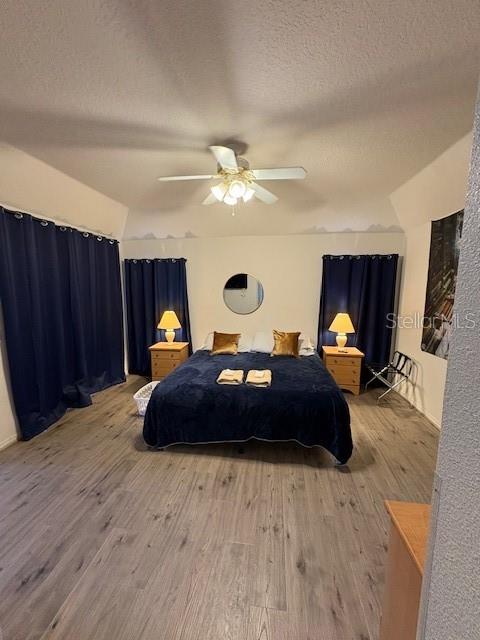 8410 Secret Key Cove Kissimmee, FL 34747 - Photo 14 of 41 a bedroom with a large bed and a chandelier