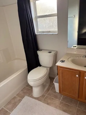 a bedroom with bed and a painting on the wall