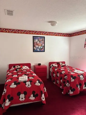 a view of a livingroom with wooden floor and cabinet