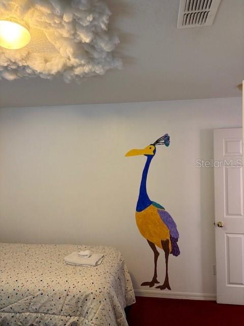 8410 Secret Key Cove Kissimmee, FL 34747 - Photo 32 of 41 a bedroom with a bed and chandelier